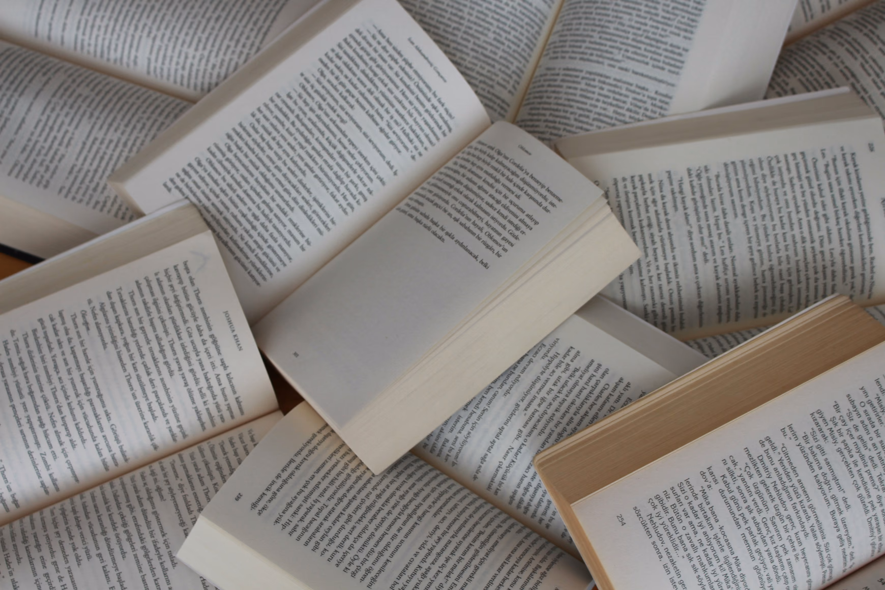 Pile of open paperback books